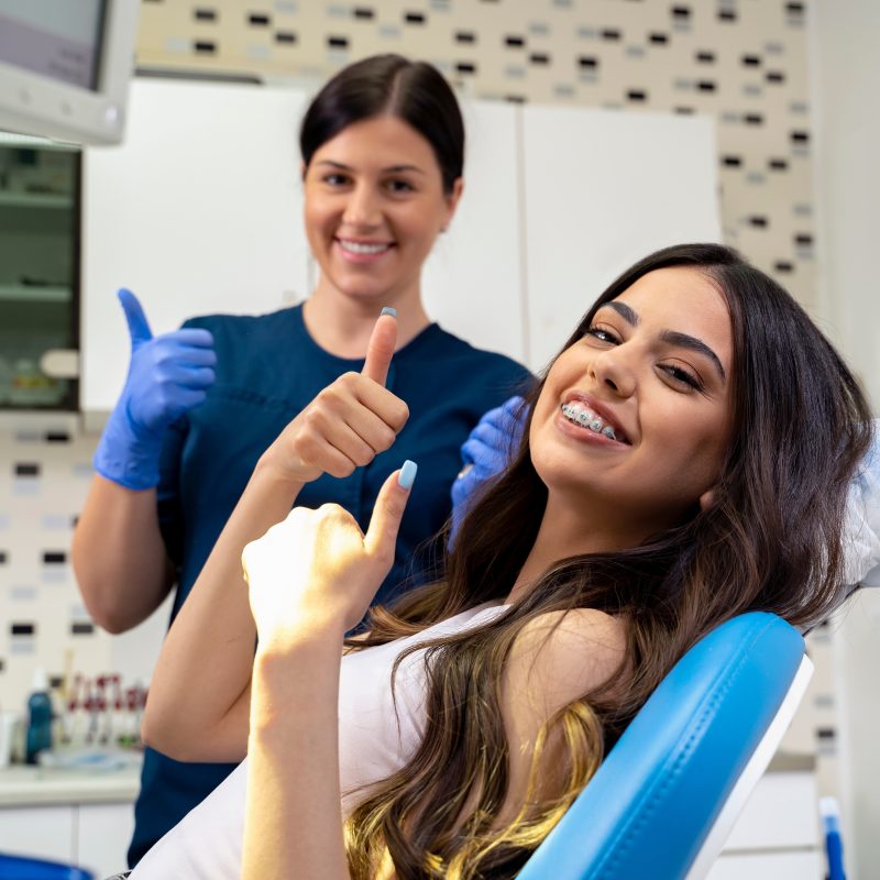 beautiful,young,woman,with,dental,braces,sitting,in,dentist,chair