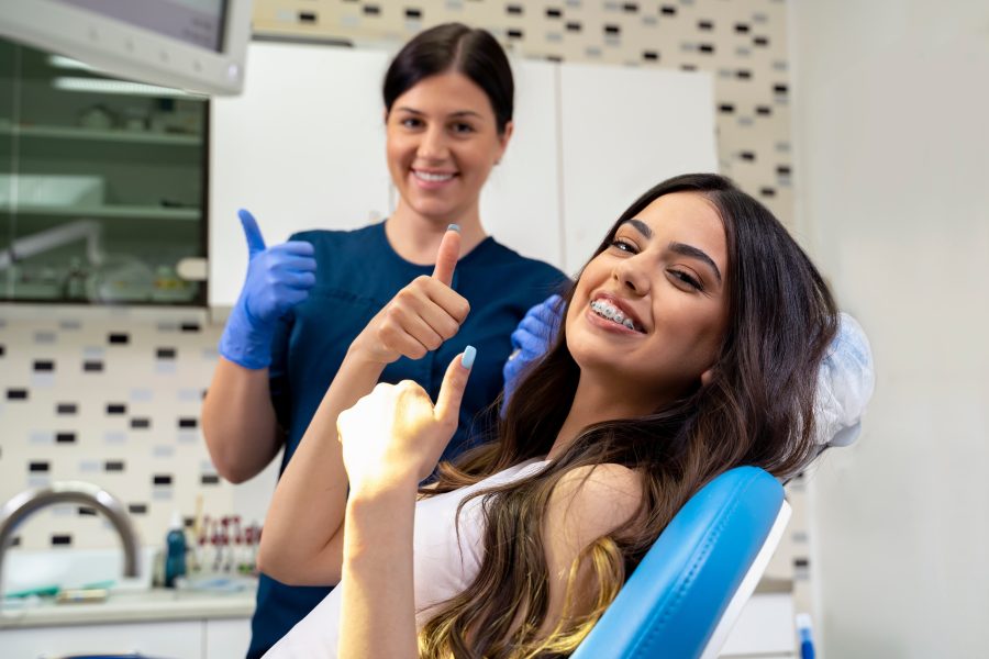 beautiful,young,woman,with,dental,braces,sitting,in,dentist,chair