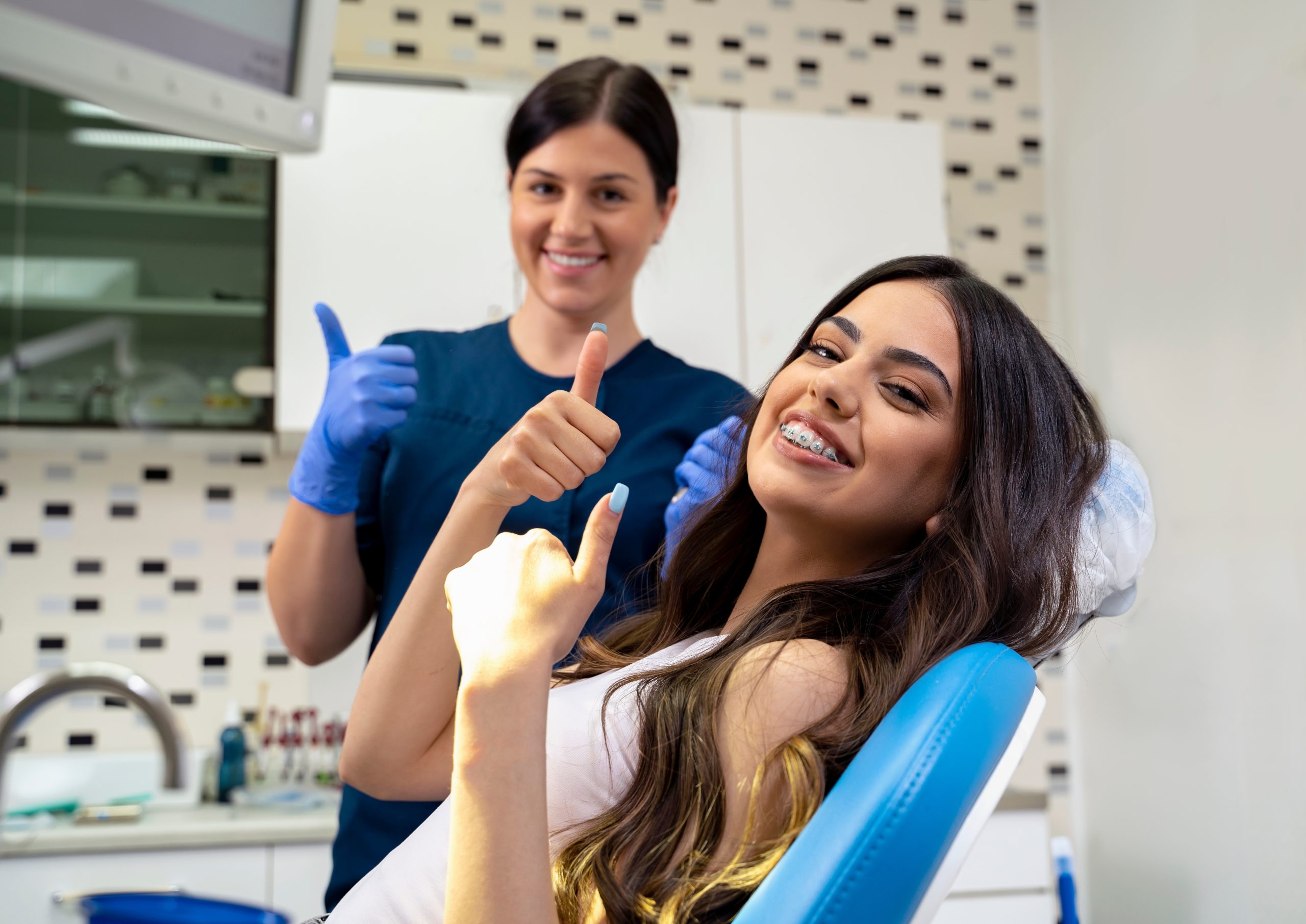 beautiful,young,woman,with,dental,braces,sitting,in,dentist,chair